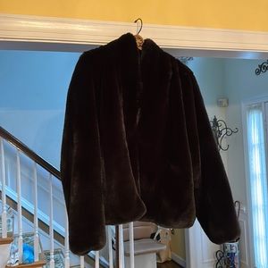 A beautiful black imitation fur jacket.